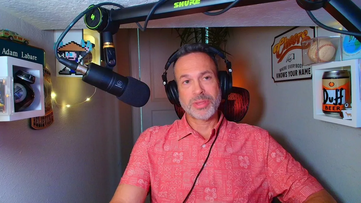Adam live at his desk, building in front of the room