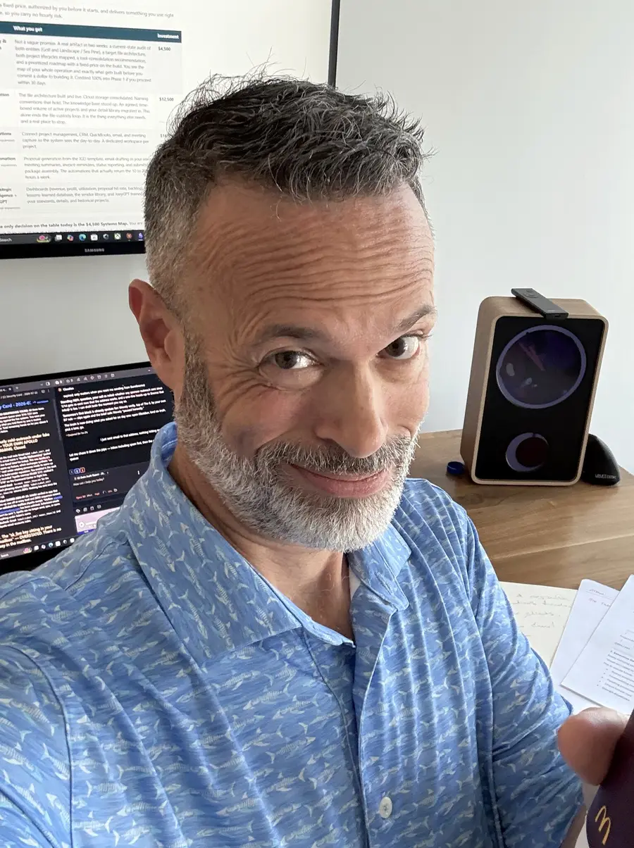 Adam LaBare at his desk, two screens behind him